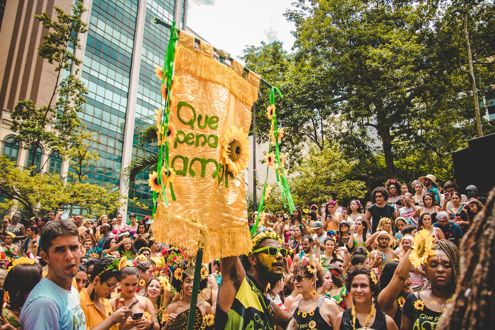A crowd of people dancing in the street at a free carnival bloco in Rio de Janeiro