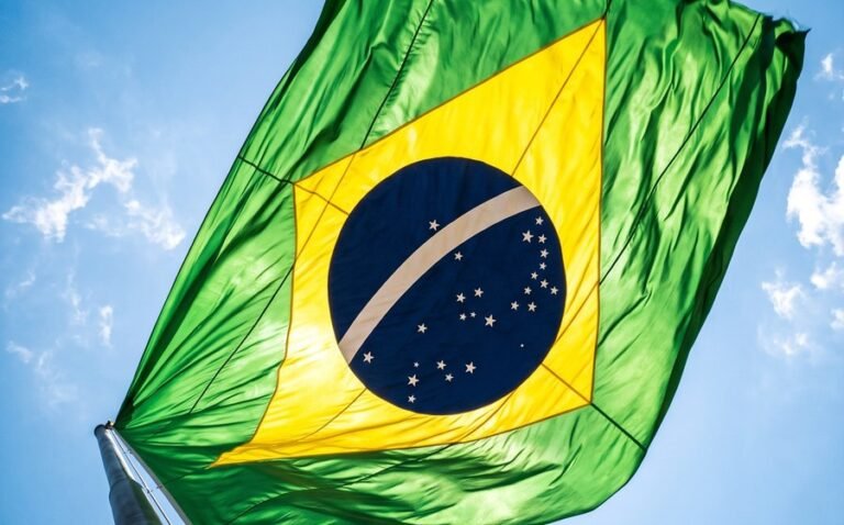 The Brazilian flag against a clear sky